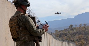 A Turkish soldier controls a drone near security walls, Hakkari province, Türkiye, Dec. 3, 2025. (AA Photo)