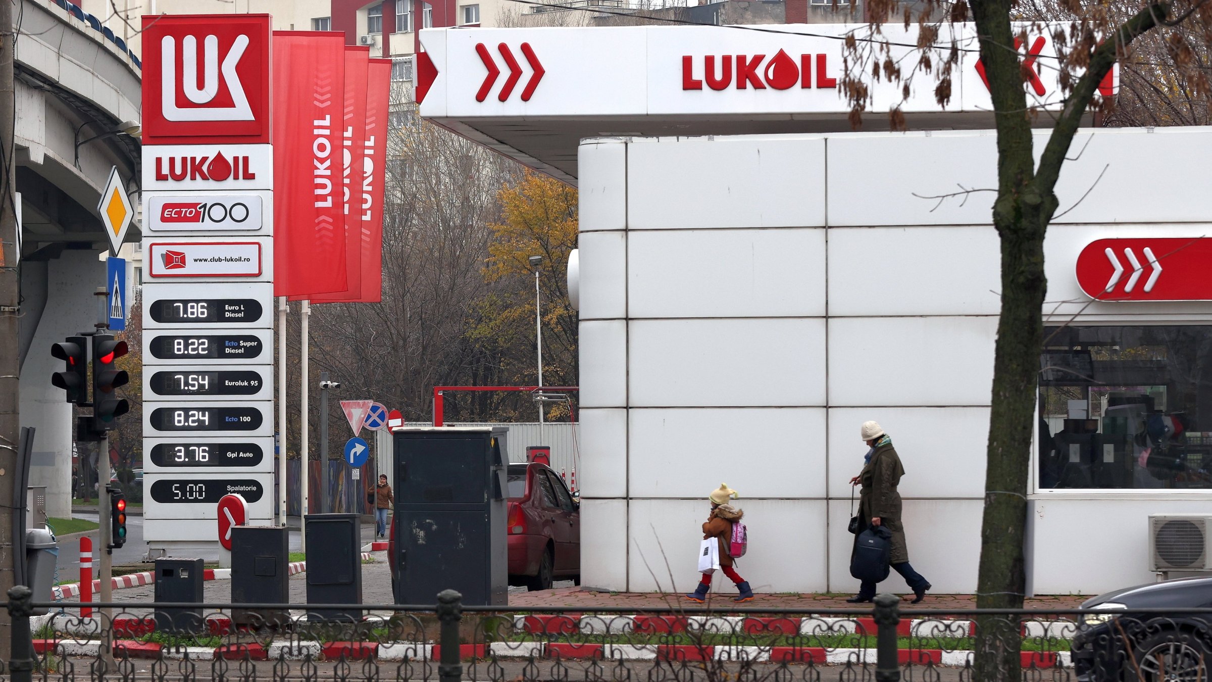 People pass by a Lukoil gas station in Bucharest, Romania, Dec. 3, 2025. (EPA Photo)