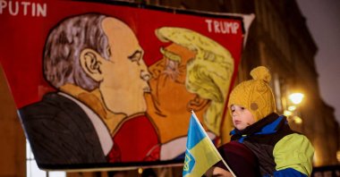 Protesters display a banner with caricatures of Russian President Vladimir Putin and U.S. President Donald Trump as people demonstrate against Trump&#039;s 29-point peace plan, in front of the U.S. Embassy, Prague, Czechia, Nov. 25, 2025. (Reuters Photo)