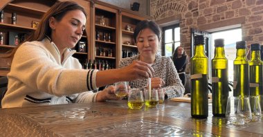 Japanese chef Hiromi Nakamura (R) prepares a special blend of Turkish olive oils with Turkish entrepreneur Bahar Alan, Ankara, Türkiye, Nov. 7, 2025. (AA Photo)