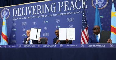 U.S. President Donald Trump, President of the Democratic Republic of the Congo Felix Tshisekedi and President of Rwanda Paul Kagame hold a signed document during a signing ceremony at the U.S. Institute of Peace in Washington, D.C., U.S., Dec. 4, 2025. (Reuters Photo)