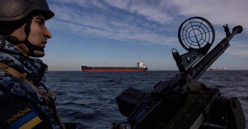 A serviceman in Ukraine&#039;s coast guard mans a gun on a patrol boat as a cargo ship passes by in the Black Sea, Feb. 7, 2024. (Reuters File Photo)