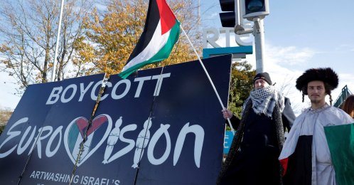 Pro-Palestinian protestors hold a flag and a banner outside the RTE (Radio Telefis Eireann) Irish public service broadcaster television studios as demonstrators call for an Irish boycott of the 2026 Eurovision Song Contest if there is Israeli participation, in Dublin, Ireland, Nov. 1, 2025. (Reuters File Photo)