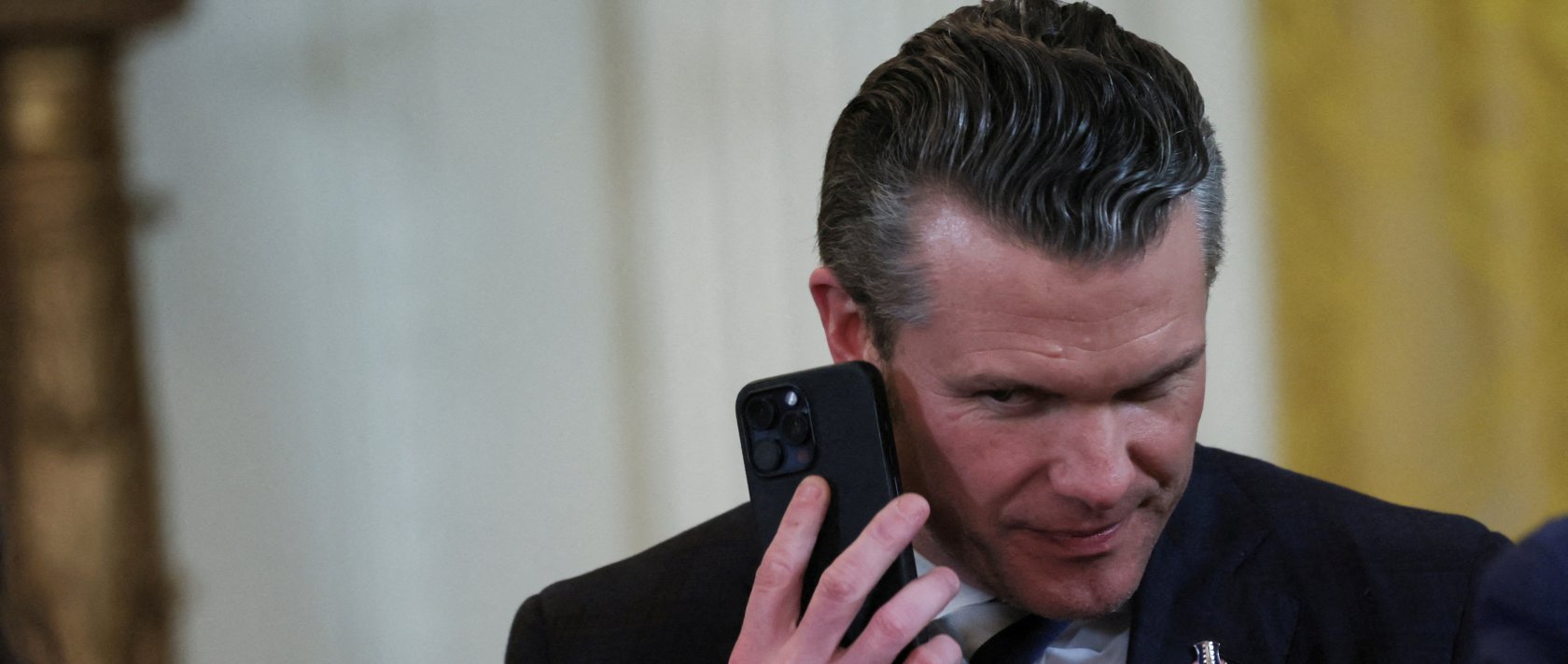 U.S. Defense Secretary Pete Hegseth uses a phone as he attends a joint press conference of U.S. President Donald Trump and Israeli Prime Minister Benjamin Netanyahu in the East Room at the White House, Washington, U.S., Feb. 4, 2025. (Reuters Photo)