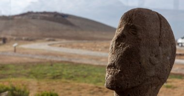 A human statue is displayed behind a glass protection at the Karahantepe excavation site, near the southeastern city of Şanlıurfa, Türkiye, Nov. 26, 2025. (Reuters Photo)
