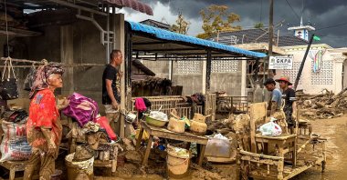 Villagers affected by flash floods clean mud from their home and belongings in Aek Ngadol village, South Tapanuli Regency, North Sumatra, Indonesia, Dec. 5, 2025. (AFP Photo)