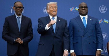 US President Donald Trump (C) gestures as he hosts the signing ceremony of a peace deal with the President of Rwanda Paul Kagame (L) and the President of the Democratic Republic of the Congo, Felix Tshisekedi, at the United States Institute of Peace in Washington, U.S., Dec. 4, 2025. (AFP Photo)
