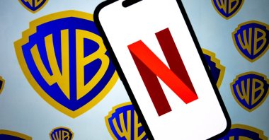 This photo illustration shows the logos of Netflix and Warner Bros. Discovery, Dec. 5, 2025. (AA Photo)