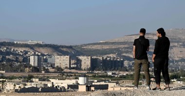 Syrian men stand on a hill in Daraya, a suburb that lies just southwest of the center of the capital Damascus, Oct. 29, 2025. (AFP File Photo)