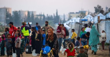 People fill their containers with water at the Nuseirat camp for displaced Palestinians in the central Gaza Strip, Dec. 4, 2025. (AFP Photo)