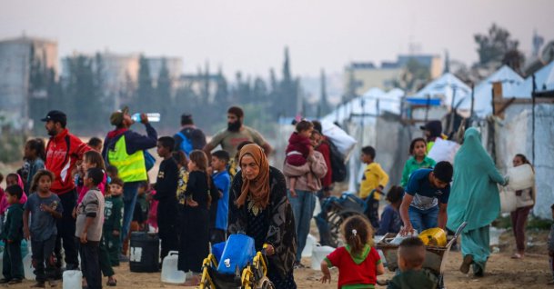 People fill their containers with water at the Nuseirat camp for displaced Palestinians in the central Gaza Strip, Dec. 4, 2025. (AFP Photo)