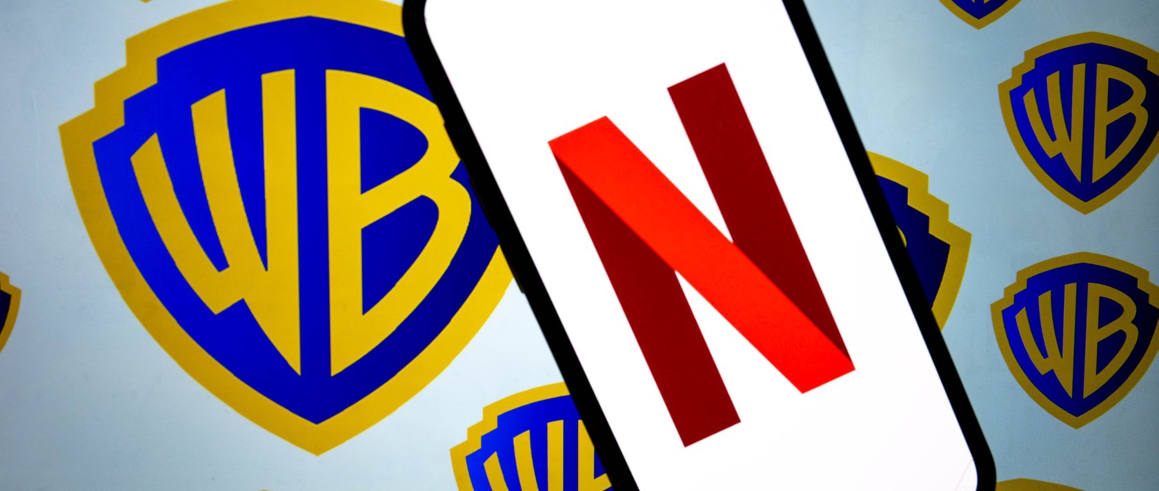 This photo illustration shows the logos of Netflix and Warner Bros. Discovery, Dec. 5, 2025. (AA Photo)