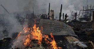 Emergency responders work at the site of a warehouse that was struck during a night of Russian missile and drone strikes, amid Russia's attack on Ukraine, in Novi Petrivtsi, outside Kyiv, Ukraine, Dec. 6, 2025. (Reuters Photo)