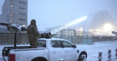 Ukrainian serviceman stands on a vehicle with anti-aircraft gun after a drone attack at the former Chernobyl nuclear power plant, Ukraine, Feb. 14, 2025. (AP Photo)