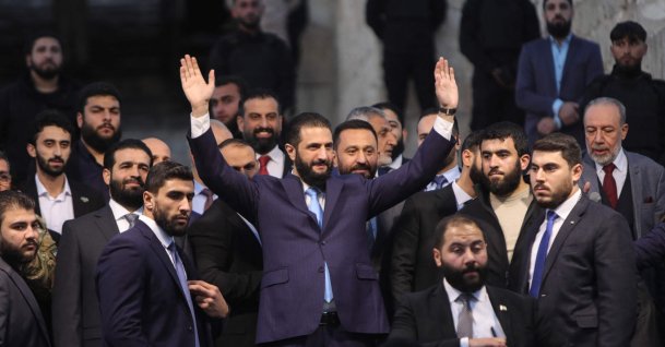 Syrian President Ahmed al-Sharaa waves to the crowd at the gate of Aleppo’s Citadel during celebrations marking one year since an alliance led by Sharaa entered the northern city and swiftly took control of it, Aleppo, Syria, Nov. 29, 2025. (AFP Photo)