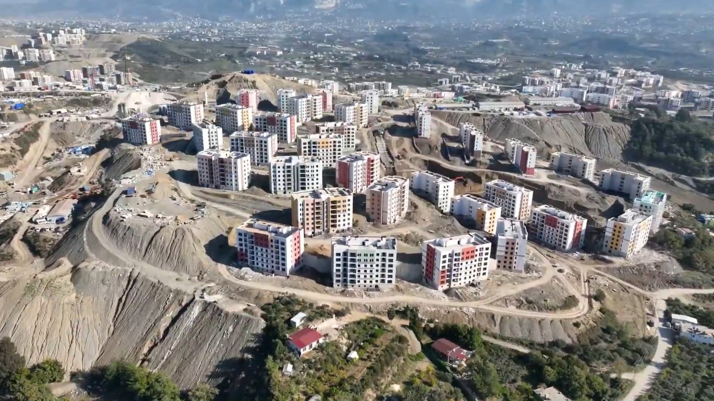 An aerial view showing the ongoing construction of 6,737 disaster-relief homes and 15 commercial centers built after the Feb. 6 earthquakes, Hatay, Türkiye, Nov. 20, 2025. (AA Photo)