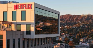 An aerial view of the Netflix logo displayed at Netflix studios, with the Hollywood sign in the distance, in Los Angeles, California, U.S., Dec. 5, 2025. (AFP Photo)