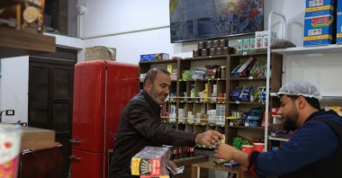 Abdullah Dibo (L) works in his shop, Aleppo, Syria, Dec. 7, 2025. (AA Photo)