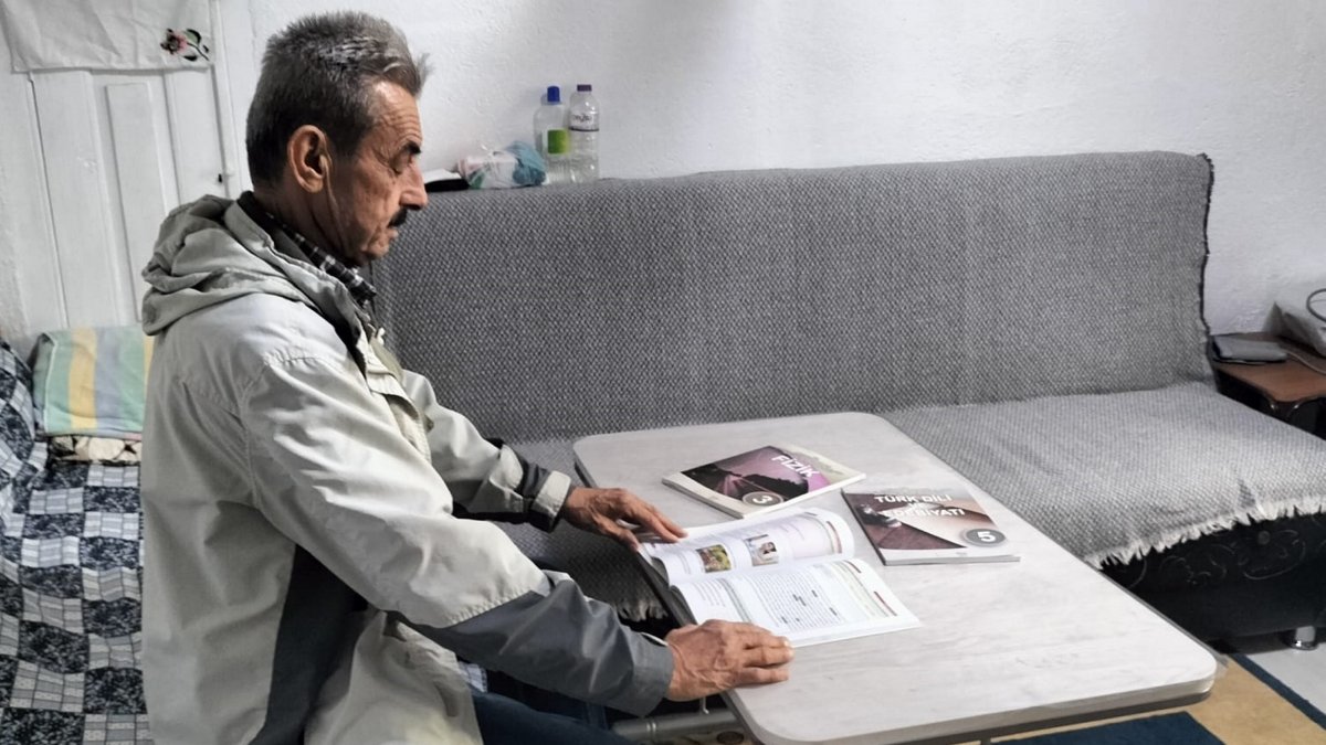 Sezai Aytekin holds his high school diploma with pride while studying for the university entrance exam at his home, Afyonkarahisar, Türkiye, Dec. 2, 2025. (AA Photo)