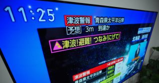 A tsunami warning is displayed on a television in Yokohama, near Tokyo, Monday, Dec. 8, 2025, after a strong earthquake hits off Japanese northern coast, tsunami alert issued. (AP Photo)