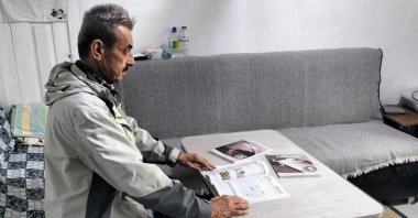Sezai Aytekin holds his high school diploma with pride while studying for the university entrance exam at his home, Afyonkarahisar, Türkiye, Dec. 2, 2025. (AA Photo)