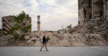 Syrian journalist Nebiha Taha walks around the ruins of the Syrian civil war, Syria, Dec. 8, 2025. (AA Photo)