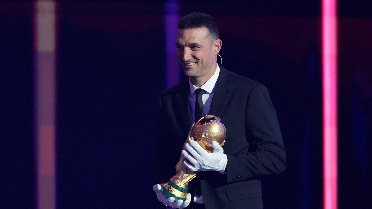 Argentina coach Lionel Scaloni brings the World Cup trophy onto the stage during the FIFA World Cup 2026 draw at the John F. Kennedy Center for the Performing Arts, Washington, U.S., Dec. 5, 2025. (Reuters Photo)
