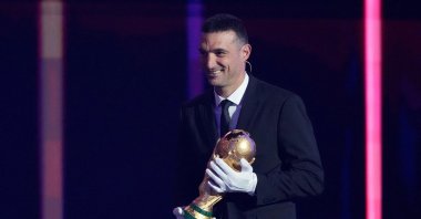 Argentina coach Lionel Scaloni brings the World Cup trophy onto the stage during the FIFA World Cup 2026 draw at the John F. Kennedy Center for the Performing Arts, Washington, U.S., Dec. 5, 2025. (Reuters Photo)