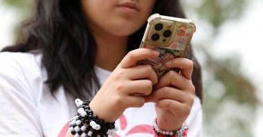 Annie Wang, 14, poses after an interview discussing Australia’s social media ban for users under 16, Sydney, Australia, Nov. 22, 2025. (Reuters Photo)