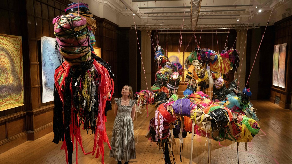 A person poses with an art installation entitled &quot;Conversations&quot; by artist Nnena Kalu, which has been shortlisted for the Turner Prize, Cartwright Hall Art Gallery, Bradford, U.K., Sept. 23, 2025. (AFP Photo)