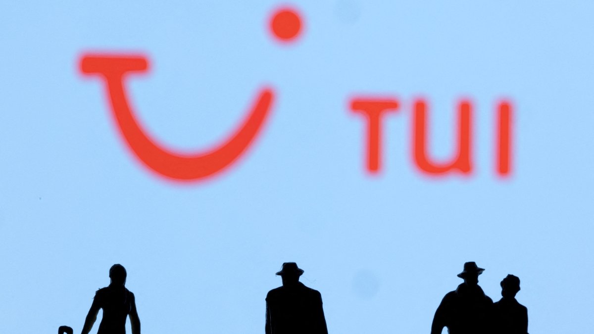 Figurines are seen in front of the TUI logo, Feb. 27, 2022. (Reuters Photo)