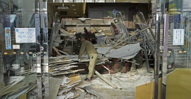 A worker cleans up inside a commercial facility in Hachinohe following a strong earthquake the previous night, Aomori Prefecture, Japan, Dec. 9, 2025. (Reuters Photo)