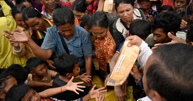People gather to receive aid at a temporary camp after they evacuated amid clashes along the Cambodia-Thailand border, Siem Reap province, Cambodia, Dec. 10, 2025. (AFP Photo)