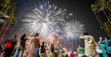 Local residents watch fireworks light up the sky as part of Diwali celebrations, the Hindu festival of lights, Mumbai, India, Oct. 22, 2025.  (AFP Photo)