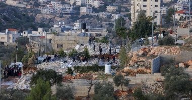People stand on the rubble of two homes belonging to Palestinians that were demolished by Israel&#039;s security forces for reportedly being built without permits in the village of Husan near Bethlehem, in the occupied West Bank, Dec. 9, 2025. (AFP Photo)
