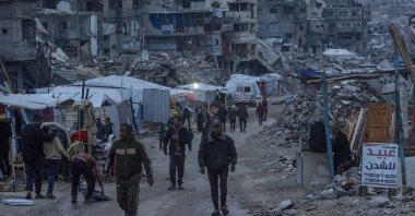Displaced Palestinians walk among destroyed buildings in the Sheikh Radwan neighborhood of Gaza City, Dec. 10, 2025. (EPA Photo)