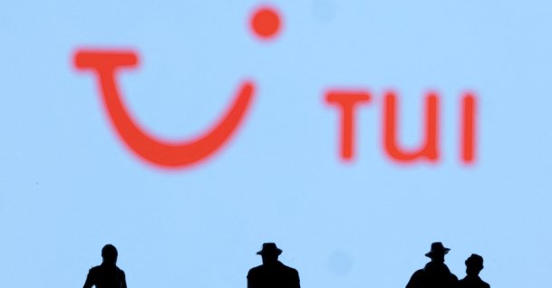 Figurines are seen in front of the TUI logo, Feb. 27, 2022. (Reuters Photo)