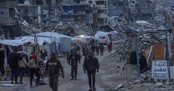 Displaced Palestinians walk among destroyed buildings in the Sheikh Radwan neighborhood of Gaza City, Dec. 10, 2025. (EPA Photo)
