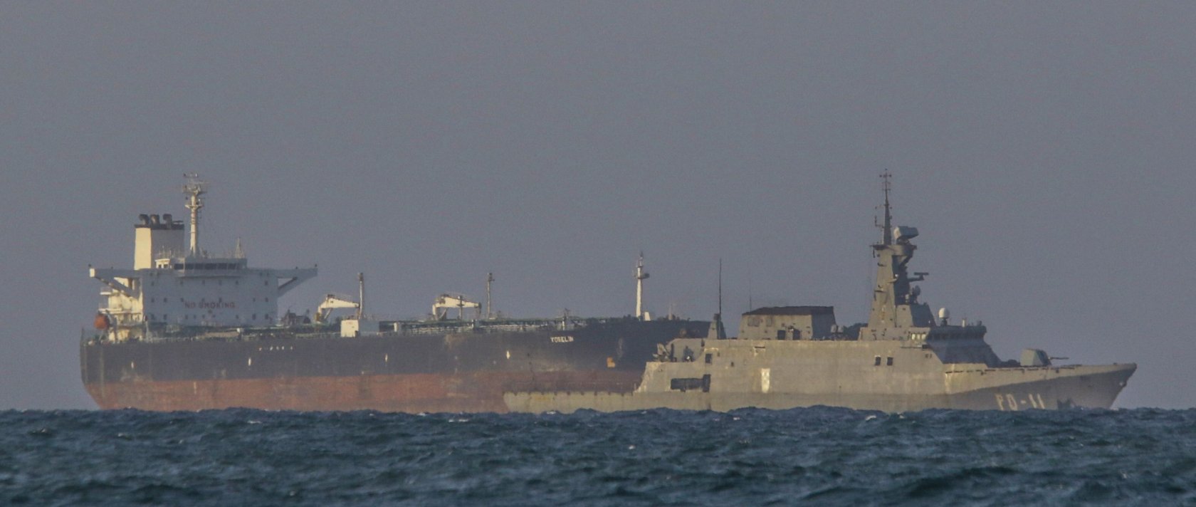 A Venezuelan navy patrol boat escorts Panamanian flagged crude oil tanker Yoselin near the El Palito refinery in Puerto Cabello, Venezuela, Nov. 11, 2025. (AFP Photo)