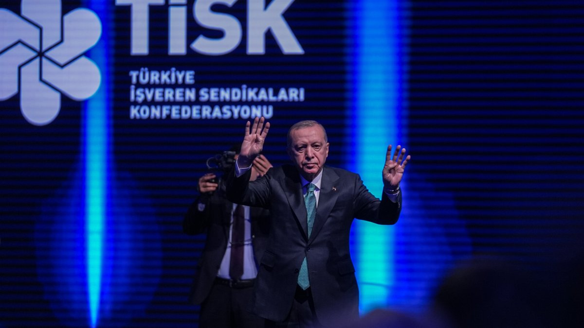 President Recep Tayyip Erdoğan greets the audience as he arrives for the TISK event, Ankara, Türkiye, Dec. 11, 2025. (AA Photo)