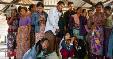 Mourners grieve as bodies are laid out at a cemetery before their burial following a Myanmar military air strike at a hospital that killed more than 30 people, Mrauk U, Myanmar, Dec. 11, 2025. (AFP Photo)