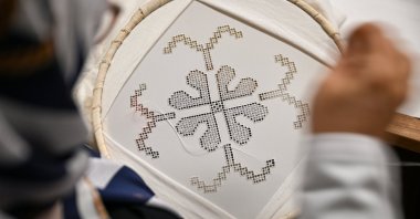 A craftswoman stitches traditional Antep Işi embroidery, Dec. 11, 2025. (AA Photo)