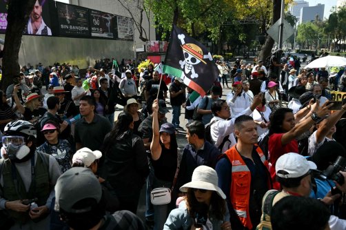 A protester holds a flag bearing the logo of the popular Japanese manga One Piece, a symbol adopted by Gen Z protest movements worldwide, during in a rally called by Generation Z against the government of Mexico&#039;s President Claudia Sheinbaum, along Reforma Avenue, Mexico City, Mexico, Nov. 20, 2025. (AFP Photo)