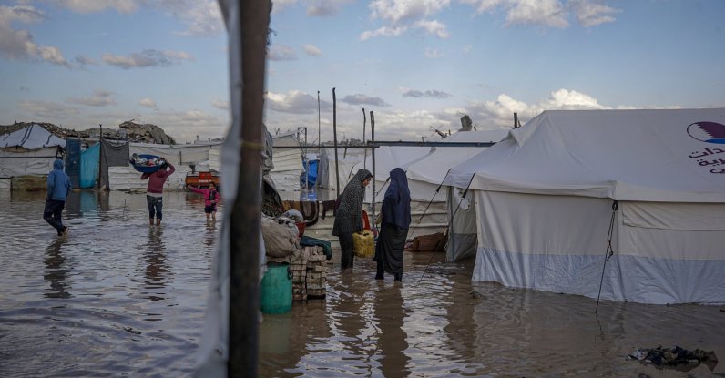 Internally displaced Palestinians wade through flood water following heavy downpours in the Al Zaitun neighbourhood in the east of Gaza City, Gaza Strip, Nov. 25, 2025. (EPA Photo)