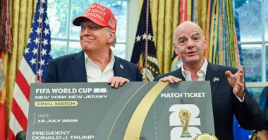U.S. President Donald Trump (L) and FIFA President Gianni Infantino hold a ticket to the final of the 2026 FIFA World Cup in the Oval Office of the White House, Washington, U.S., Aug. 22, 2025. (Getty Images Photo)