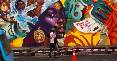 People walk past a mural on Ozumba Mbadiwe Way, during the Lagos Street Art Festival in Victoria Island, Lagos, Nigeria, Dec. 11, 2025. (Reuters Photo)