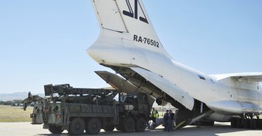 Military officials work around a Russian transport aircraft, carrying parts of the S-400 air defense systems, after it landed at Murted military airport, Ankara, Türkiye, Aug. 27, 2019. (AP Photo)