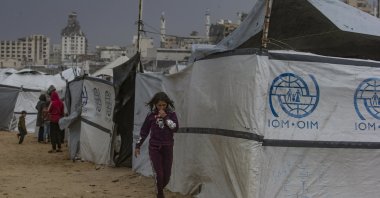 Displaced Palestinians wait outside their shelters on a rainy day, Gaza City, Palestine, Dec.11, 2025. (EPA Photo)