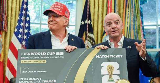 U.S. President Donald Trump (L) and FIFA President Gianni Infantino hold a ticket to the final of the 2026 FIFA World Cup in the Oval Office of the White House, Washington, U.S., Aug. 22, 2025. (Getty Images Photo)