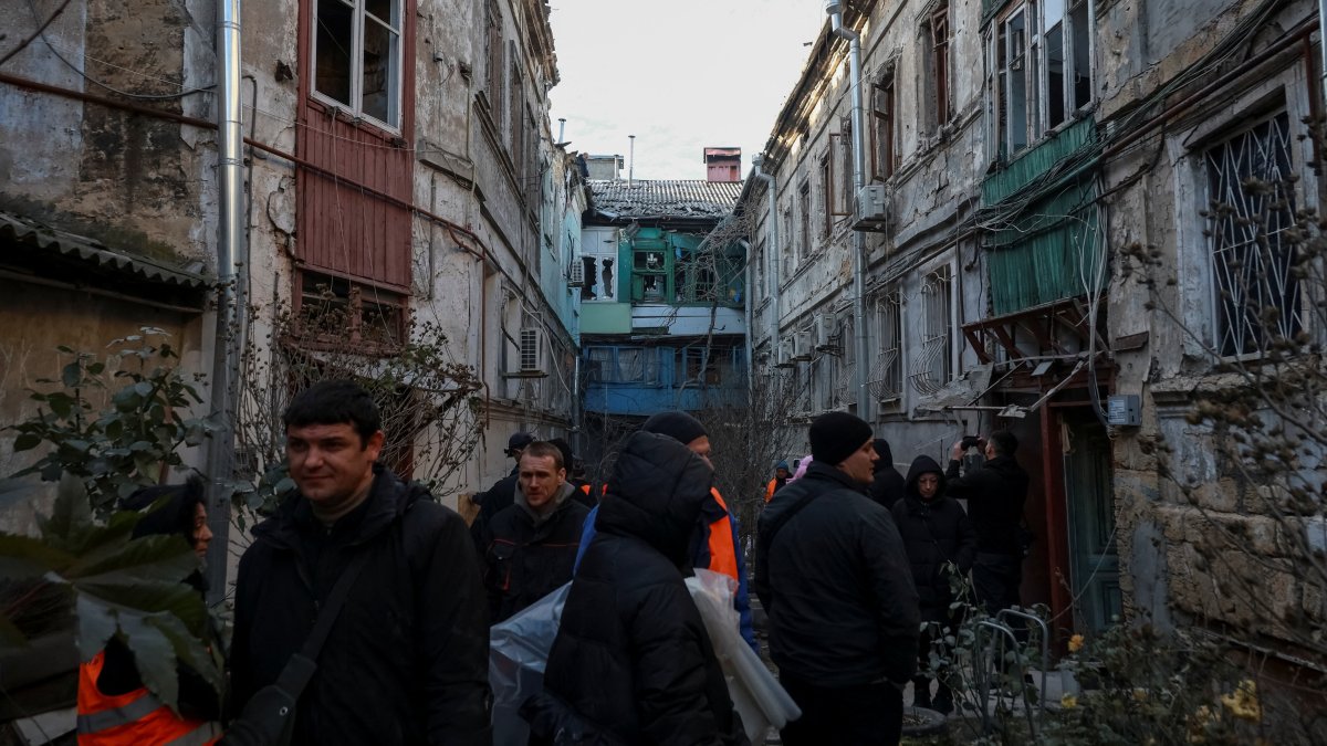 Residents stand near damaged apartment buildings at the site of a Russian missile and drone strike, amid Russia&#039;s attack on Ukraine, in Odesa, Ukraine Dec. 13, 2025. (Reuters Photo)